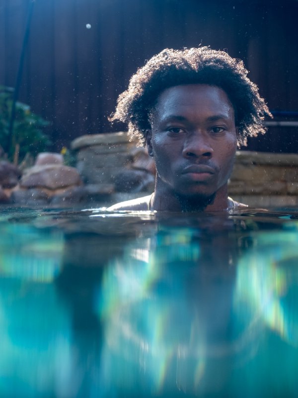 Underwater portrait emerging from the water, shot in a North Texas pool