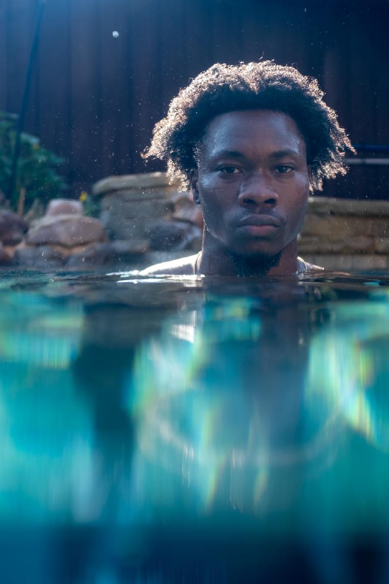 Underwater senior portrait session in a private pool