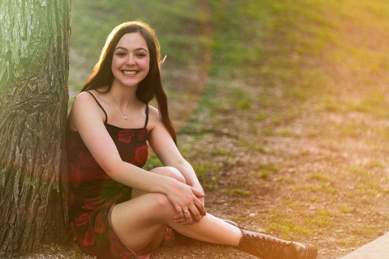 Golden hour senior portrait of Hailey at a Frisco park