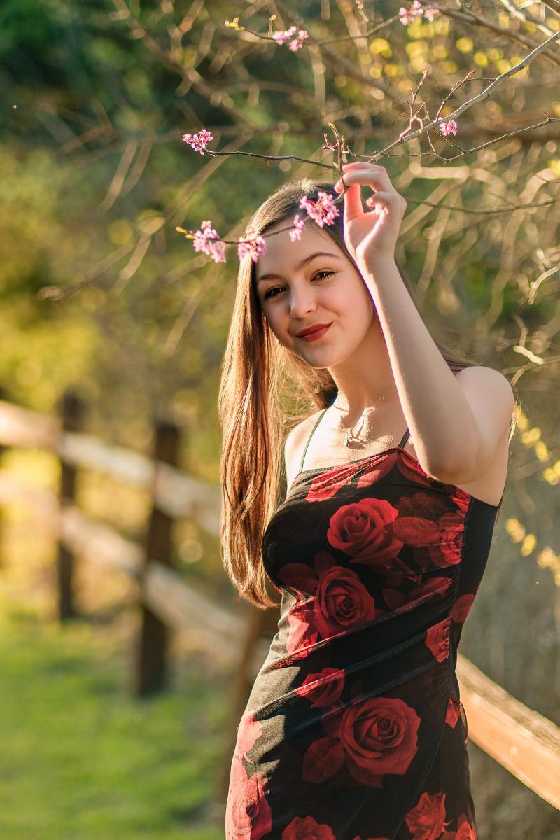 Golden hour senior portrait of Hailey at Limestone Quarry Park in Frisco