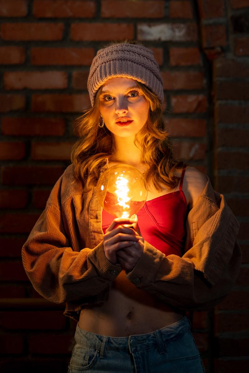 Studio-style senior portrait with off-camera flash lighting