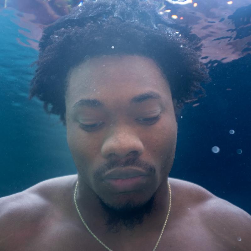 Close-up underwater portrait with natural light filtering through the water