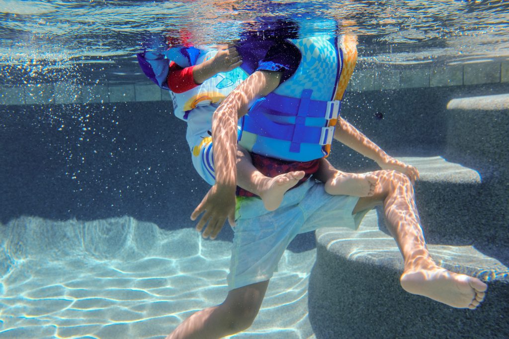 Boys playing underwater